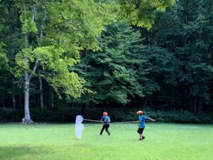 広場で網を持って走る子どもたち