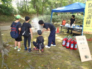 消火器から水を出す子ども