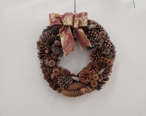 マツボックリをふんだんに使った赤いリボンのリース
