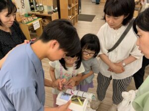 トンボを見せてもらう子供