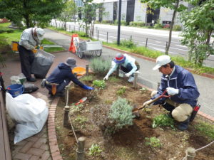 花くらぶのメンバーと職員で花壇を起こす様子