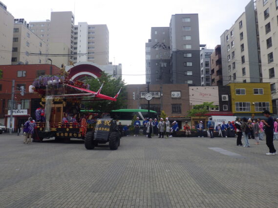 札幌まつりの東地区第7祭典区の山車が狸二条広場に入る様子